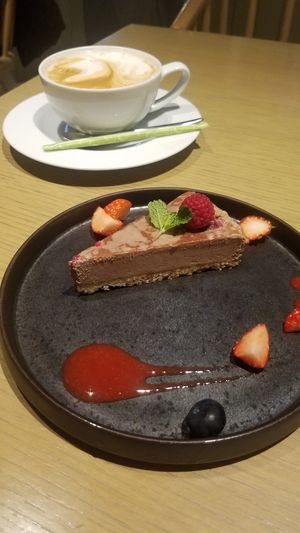 Raspberry cacao raw cake and soy latte  at Cosme Kitchen Adaptation - Atre West in Tokyo