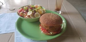 Bean burger and fruit salad at Veganza Cafe in Auroville