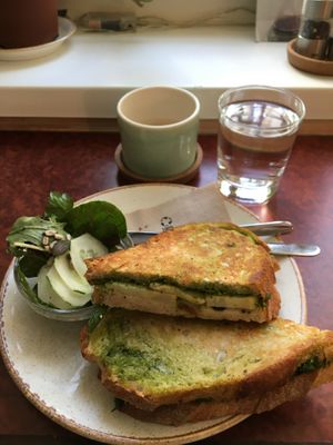Vegan sandwich of the day included a side salad, tap water included, and ordered an oat milk chai latte at haepinest in Innsbruck