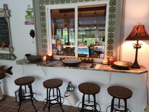 Outdoor pool deck at Pirate Palms Plant-Centered Retreats in Naples