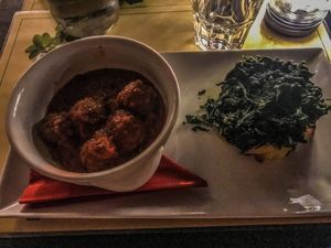 Vegan "meatballs" in tomato sauce with sautéed seasonal vegetables and roasted potatoes at Origano Campo de' Fiori in Rome