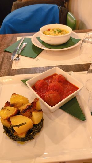 Vegan meatballs dish (front) and pesto gnocchi (back) at Origano Campo de' Fiori in Rome