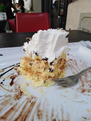 3 layers of custard and chocolate chips, 2 layers of flaky pastry, vegan whipped cream and chocolate sauce. at Origano Campo de' Fiori in Rome