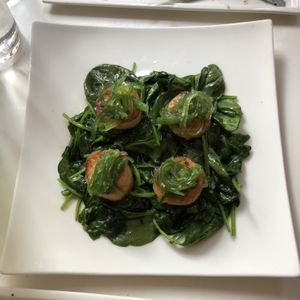 The spectacular roasted (vegan) scallops — tastes and feels just like the seafood — on a bed of garlic spinach, with seaweed highlights at Delice & Sarrasin in New York City