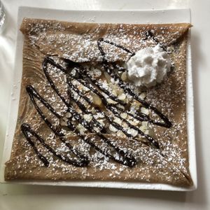 La Nanane, roasted pears, dark chocolate, slivered almonds, and whipped cream at Delice & Sarrasin in New York City