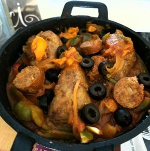 poulet basquaise, V. chicken legs slowly marinated with v. chorizo, melted peppers, onions & tomatoes served with couscous
 at Delice & Sarrasin in New York City