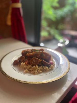 Poulet basquaise Chicken peppers on semolina (Cous cos). Good but needed a sauce or olive to bring it together  at Delice & Sarrasin in New York City