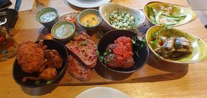Sharing Platter - Marinated tofu with garlic & cucumber sauce, cauliflower
popcorn, tomato & oregano plantballs, soup of the day,
tabbouleh, grilled vegetables, olives, sriracha ma at The Allotment in Manchester