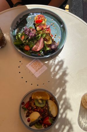 plate with different breads on top. granola, yoghurt dish below  at Joy Healthyfood in Montpellier