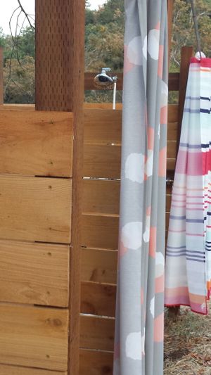 Outdoor Bathhouse with private stalls. at Morriplum Farm Sanctuary & Retreat in Medford