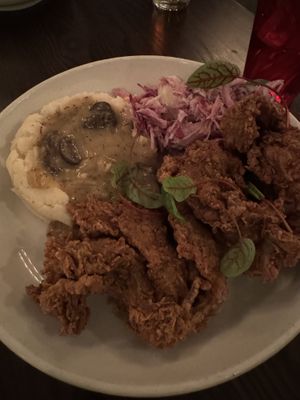 Oyster mushroom fried chicken. The mashed potatoes are fine, gravy is pretty good, too much mayo on the slaw, and the mushrooms taste like nothing at all    at Modern Love in Brooklyn