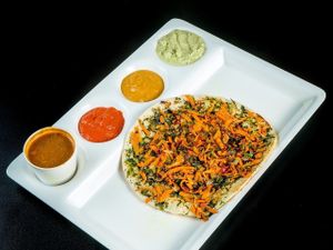 Masala uttahpam ... ( Vegan ) 

Flat Pancake made of rice flour with .. onion , carrot , chilli , cilantro and special spice powder for perfection ...
Also includes lentil soup , 3 dipping sauce 9 Onion , Ginger , Coconut ,) its not spicy if no chilies  added  at Chowpatty Express in Katy