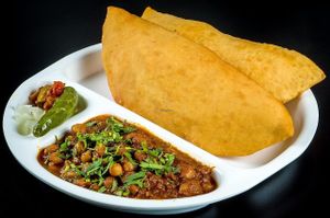 Falten Bread Made With All Purpose Flour and mixture 
( Contain Milk ) ...but can be substituted with poori instead 
Served With Garbanzo Beans Curry  at Chowpatty Express in Katy