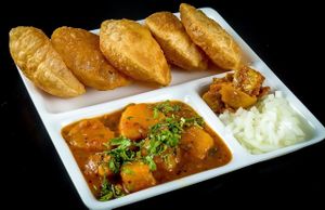 Flaten Wheat Bread deep Fried Served With Potato Curry at Chowpatty Express in Katy
