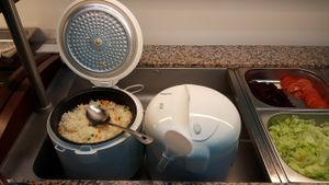 The new asian buffet has rice directly from the ricecooker. Plain rice and rice with some peas. at Butterfly in Basel