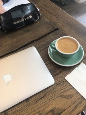 Enjoying a flat white latte   at Nuage Cafe in Paris