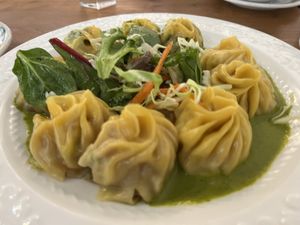 Selection of three kinds of momo with salad and slightly tangy green sauce  at Cafe Tibet in Berkeley