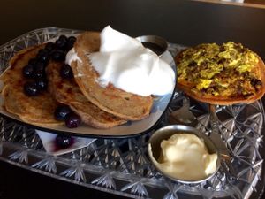 Pancakes with blueberries and aquafaba whipped cream; breakfast  pizza at The Breakfast Club in Lawrence