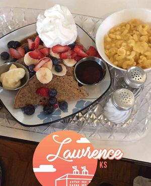 waffle batter french toast with butter, maple syrup, & whipped cream topped off with fruit + a side of mac n cheese at The Breakfast Club in Lawrence