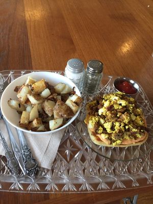 egg, sausage, & queso pizza with breakfast potatoes on the side  at The Breakfast Club in Lawrence