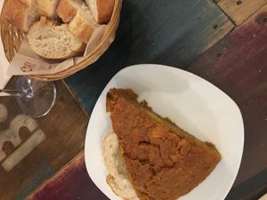 Delicious pincho/slice of tortilla served with homemade bread (3.50 euros) at El Perro Gamberro in Madrid