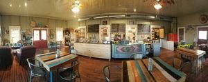 Interior with artwork on walls for sale at Tough Cookie Bakery in Bastrop