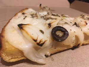 Traditional fainá - with onion and black olives at Pizza Vegana - Recoleta in Buenos Aires