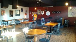 Cafe setting, local artist work on walls for sale, stage for events at Black Sheep Lounge in Welland