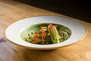 Stuffed zucchini blossom

with cashew cheese, walnuts, pink peppercorn served on rocket and basil pesto at Solo Crudo - Prati in Rome