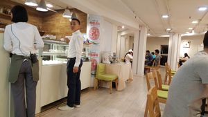 Interior, with server at the dessert case. (The cake was terrible.) at Ru if Vegan in Shanghai