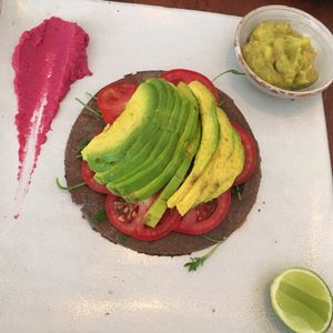 Kind of pita bread with tomato, avocado and beetroot hummus. And a side of wacamole at Vibe Cafe in Siem Reap