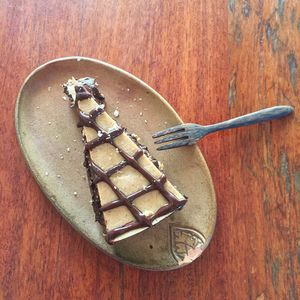 Chocolate and salted caramel tart, with banana and tahini  at Vibe Cafe in Siem Reap