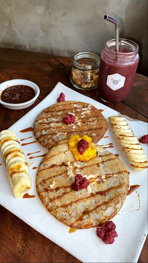 Best pancakes I ever had! Choc peanut butter, granola and banana as a side. at Vibe Cafe in Siem Reap