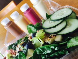 Salad and options of dressings at The Green Heart Wellness Center in Mc Minnville