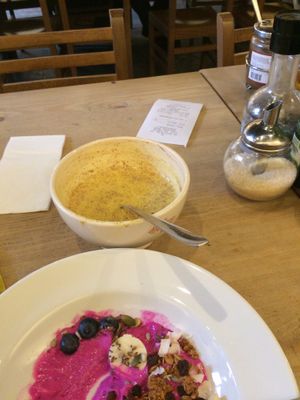 Coconut dragon fruit bowl and turmeric latte. at Le Pain Quotidien - Simon Stevinplein in Bruges