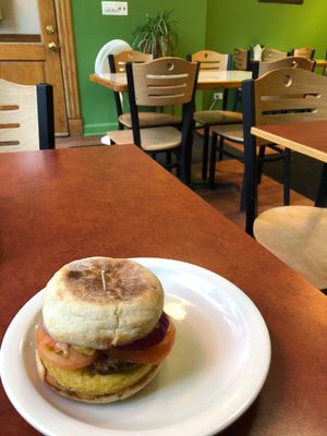 Vegan breakfast sandwich with Just Egg, “bacon,” and I added tomato and red onion. at Fancy Plants Cafe in Chicago