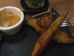 Potatoes with the vegan swiss cheese burger at La Raiz de la Tierra in Ixtapa