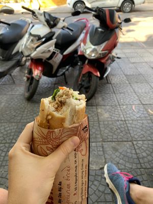 The owner woman provides a small chair to sit while you eat at Hoi Banh My Chay - Food Stall in Hoi An