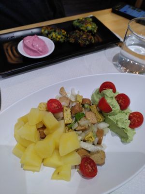 Appetizers of the daily menu. German salad with sausage and spinach croquettes at La Huella Vegana in Alcala De Henares