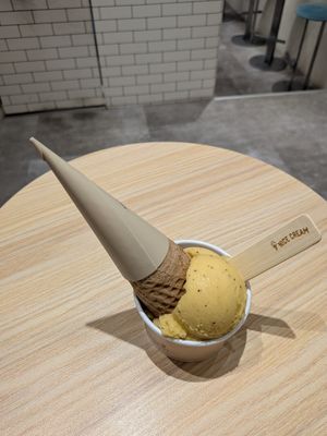 Passion fruit ice cream and oreo ice cream underneath. Cone included if you buy two scoops. at Nice Cream in Taipei