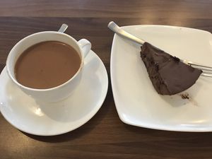 vegan massala tea and chocolate cake  at Nick's Italian Kitchen in Dharamshala