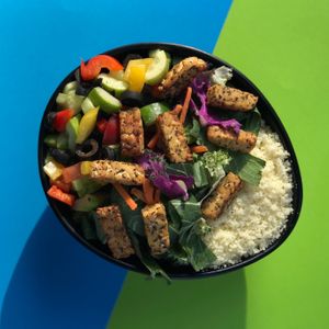 Greek Salad made with cucumbers, cherry tomatoes, bell peppers, mixed greens, black olives, tempeh feta, couscous at Sprout Korea Natural Whole Food Service in Seoul