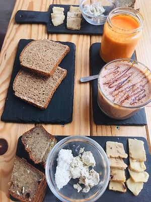 Amazing vegan cheese board with juice and 'Snickers' milkshake! at Foodprintz Cafe in Lisbon