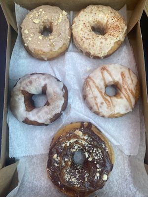 Banana chai, elote, carrot cake, guava, twix   at Nomad Donuts in San Diego