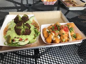 Falafel roti with loaded tots! 😍 at Curia on the Drag Food Truck in Gainesville