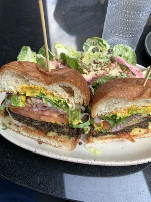 Burger and side caesar salad   at PLANTA - Yorkville in Toronto