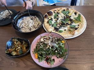 Udon noodles (top left); leek Bianca pizza (top right); bang bang broccoli (bottom left); fungi salad (bottom right)  at PLANTA - Yorkville in Toronto