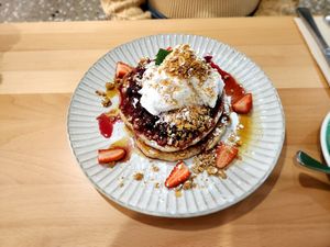 Short stack pancakes with coconut vanilla ice cream, maple syrup, and strawberries.  at Wombat Cafe & Store in Dromana