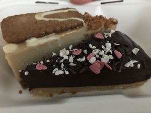 Biscoff cheesecake and chocolate cake. Sooooo awesome. Its rare that the cake is that extraordinary good. Full taste. And the takeaway box was made of recyclable materials. at Rabbit Vegan Cafe in Exeter