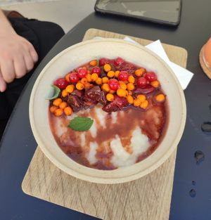 Delicious vegan rice porridge with sweet cherries and sea buckthorn, redcurrent at Fach Juice Shop in Bratislava